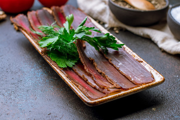 Dried sliced basturma on the Board