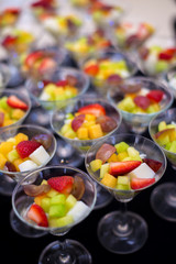 sliced several fruit prepare in row of glasses