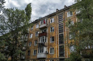 Fototapeta premium Soviet architecture. Ust-Kamenogorsk (Kazakhstan) Apartment building. Soviet architectural style. Residential building. Soviet built multistory apartment building. Soviet flag