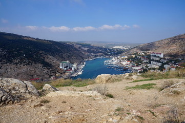 Fototapeta na wymiar Black Sea. View of Balaklava Bay and Balaklava resort on a sunny autumn day.