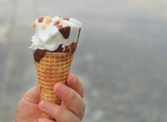 Hand Holding Ice Cream Cones with Chocolate