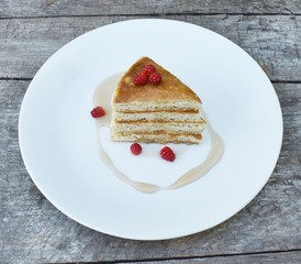 Pancake wedges with syrup and berries on white plate