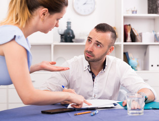 Husband is studying documents on divorce at the table