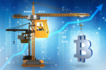 Construction crane lifting bitcoin in cryptocurrency concept