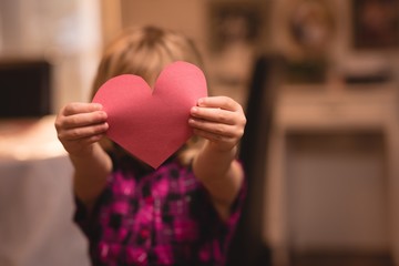 Girl holding heart shape decoration