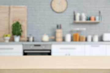 Empty table and blurred view of kitchen interior