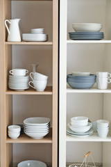Obraz na płótnie Canvas Kitchen shelving with dishes on white wall background
