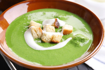 Bowl with delicious spinach soup, close up