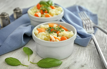 Bowl with delicious pumpkin risotto on wooden table