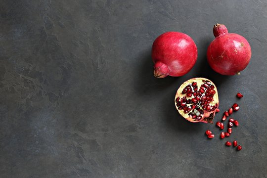 Pomegranate. Fresh Ripe Pomegranate Overhead Dark Concrete Background. Top View, Copy Space