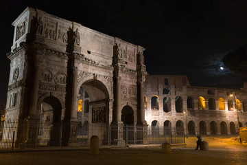 Arch monument in front of coliseum at moonlight