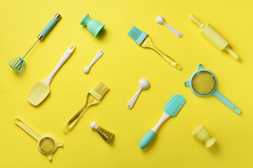 Turquoise cooking utensils on yellow background. Food ingredients. Cooking cakes and baking bread...