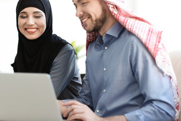 Muslim businessman with coworker in office