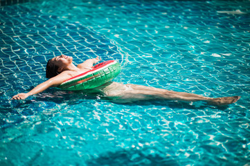 Woman  bikini relaxing in pool