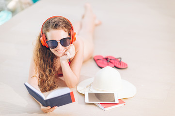 Woman in bikini relaxing on summer ,Female read a book and listen music