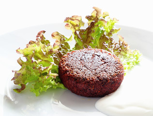 beetroot cutlet on letuce with sour cream