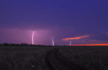 Lightnings at the field at the sunset