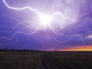 Lightnings at the field at the sunset