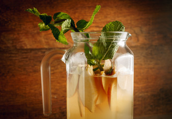 Homemade apple cider. Bottle and a glass of apple organic vinegar on a wooden background. Healthy natural probiotic drink.