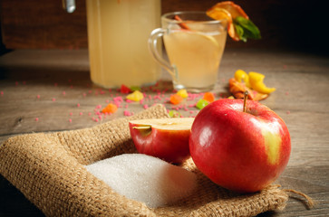 Homemade apple cider. Bottle and a glass of apple organic vinegar on a wooden background. Healthy natural probiotic drink.
