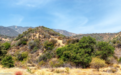 Desert mountains in southwest dry in summer sun with room for text in blue sky