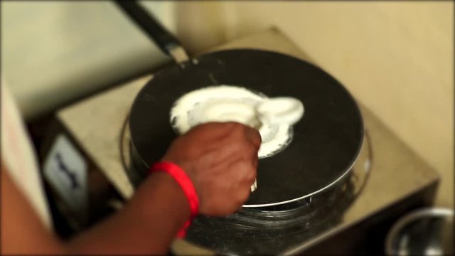 Young man hands cooking and preparing South Asian food in house kitchen. A man cooking dosa for dinner or breakfast food.