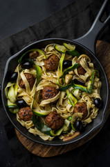 Pasta with meatballas on frying pan
