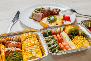 Healthy meal prep containers with vegetables, chicken, beef and shrimp grilled. Close-up, view top.