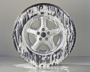 Generic Wheel with metal rim. Foamy tire being washed
