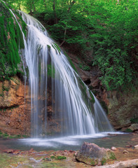 Obraz premium Big waterfall at the green forest in europe
