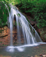 Big waterfall at the green forest in europe