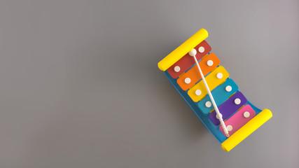 Flat lay composition with brilliant basics xylophone baby toy on color background.Top view, copy space