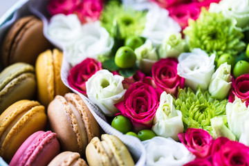 flower box with flowers and macarons composition closeup