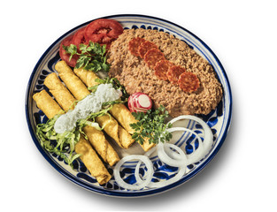 Mexican chicken Tacos with clipping path Tasty fried tacos with cream served with refried beans