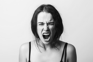 Angry screaming girl. Discontent, aggression, depression, attack, energy, cry, screaming. Black and...