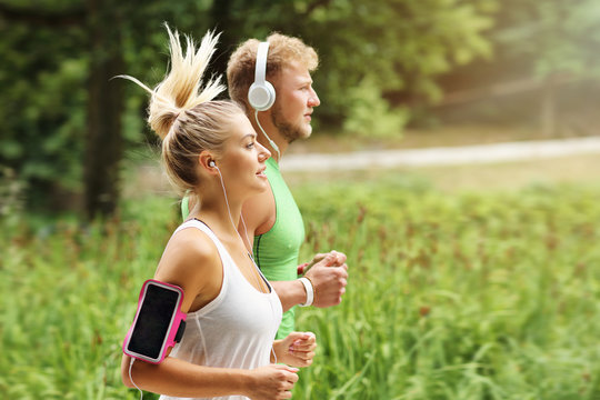 Young Couple Jogging In Park