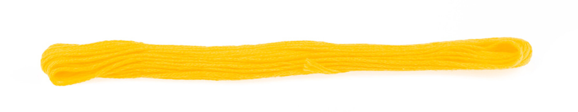 Close up yellow yarn thread isolated on white background