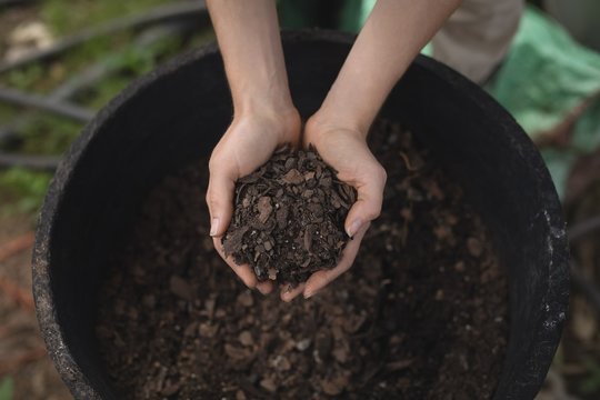 Female farmer holding a soil