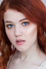 Tender retro portrait of a young beautiful dreamy redhead woman.