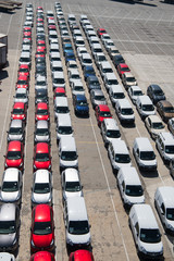 new cars in rows on parking. Auto export and import of car. Vehicles shipment. Car trade and commerce. Shipping activity. Traveling by car to Barcelona, Spain