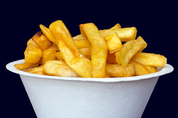 French fries in white bucket on black background, macro view.