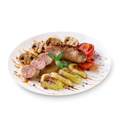 Roasted sausages with tomato sauce and vegetables on a white background