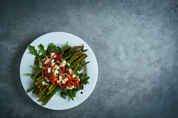 roasted asparagus with tomatoes, olives, cheese and arugula