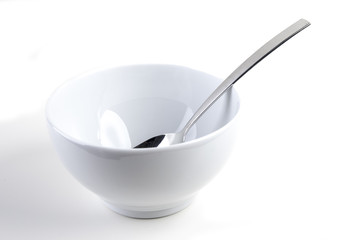 Cereal bowl with silver spoon on white background