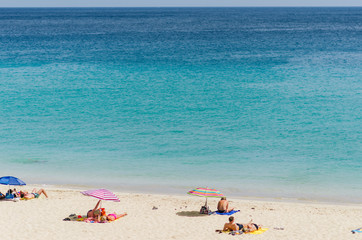 Fototapeta na wymiar Sand beach and blue ocean. Resort and relax.