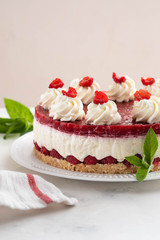 Obraz na płótnie Canvas Raspberry cheesecake with whipped cream and fresh raspberries on a white plate.Copy space.