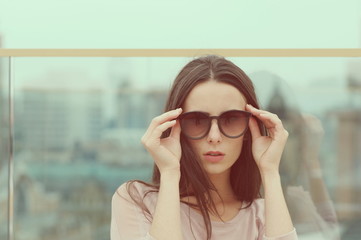 Woman plays with sunglasses