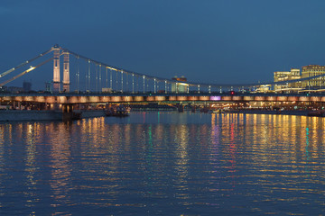 Fototapeta na wymiar Brightly illuminated bridge at the sunset in Moscow