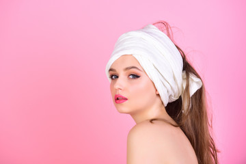 Housewife has makeup with towel or headscarf. Morning after bath washing and hair clean. Sexy woman with towel on head after shower. Girl with fashionable turban on hair. Fashion and beauty spa
