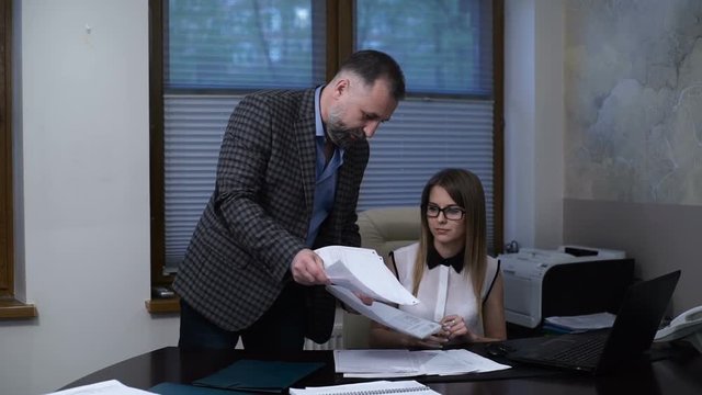 Angry boss scolds the employee, accuses an error in the report, poor performance, accuses of incompetence